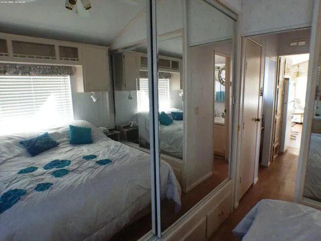 a bedroom with a bed and wooden floor