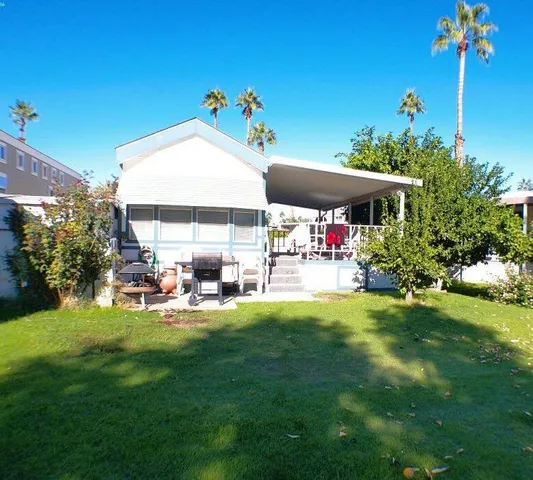 a view of a house with a yard porch and sitting area