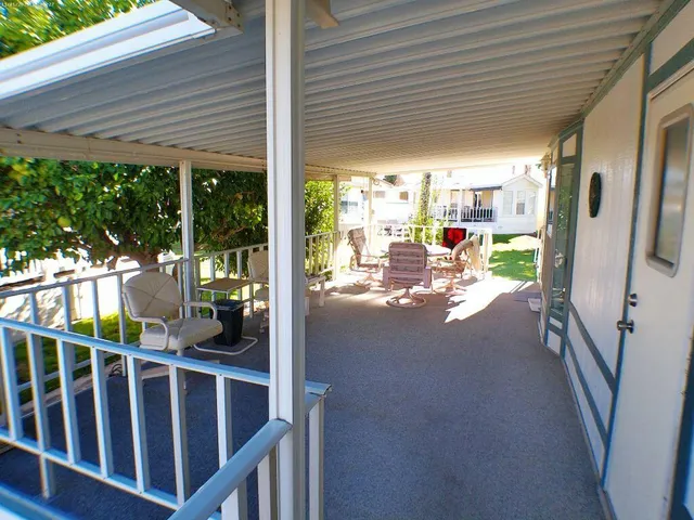 a view of a patio with chairs and backyard
