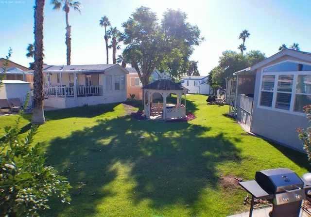 a view of an chairs and table in the backyard