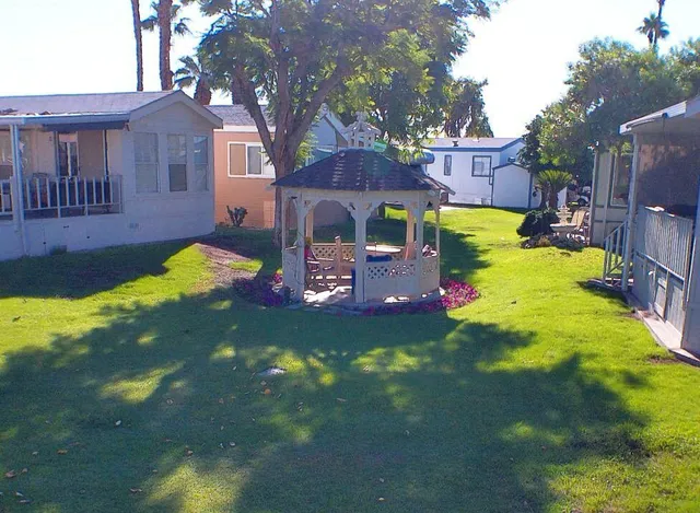 a front view of a house with swimming pool table and chairs
