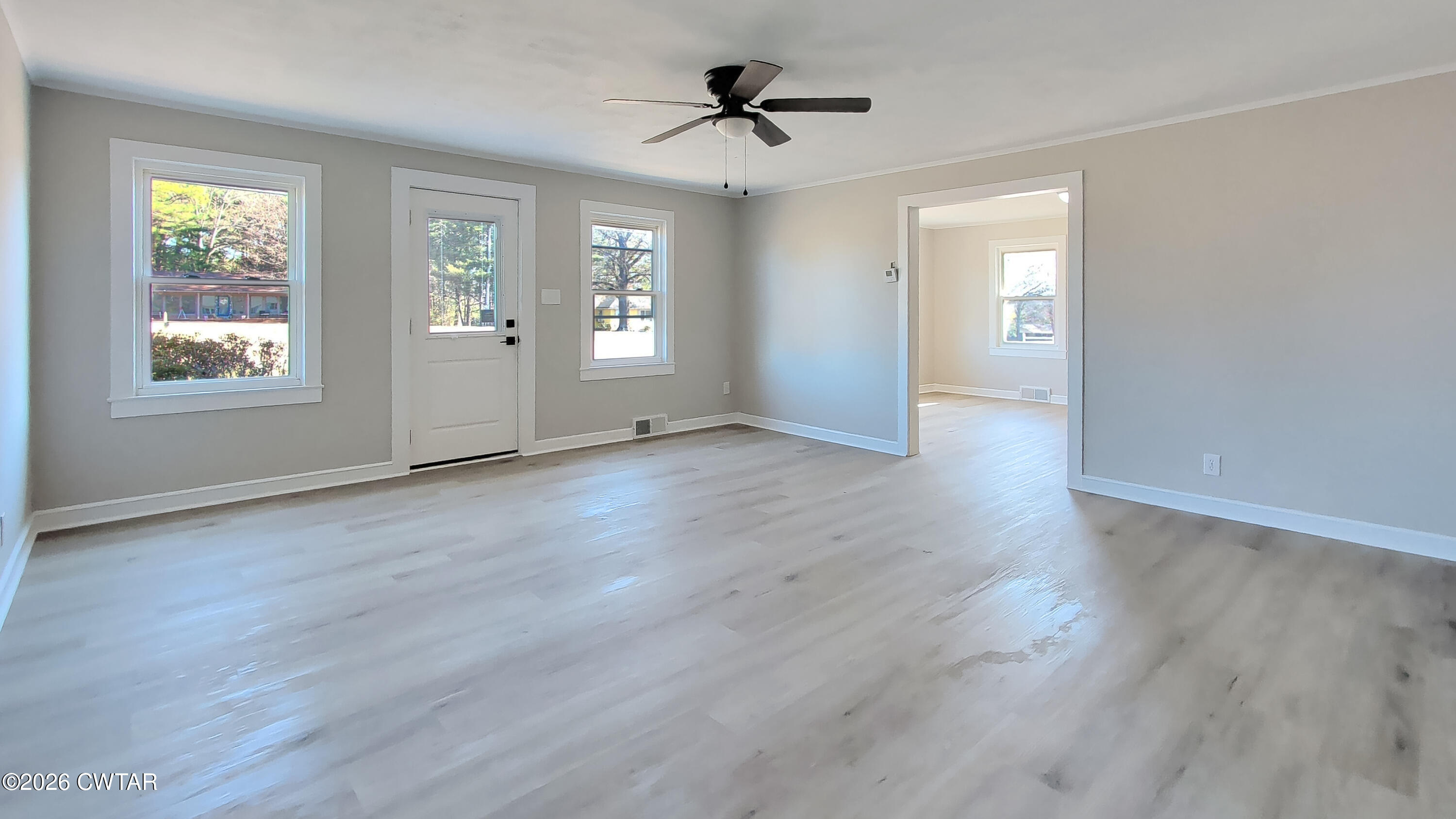 967 Broad Street North Lexington, TN 38351 - Photo 5 of 12 a view of an empty room with a window and wooden floor