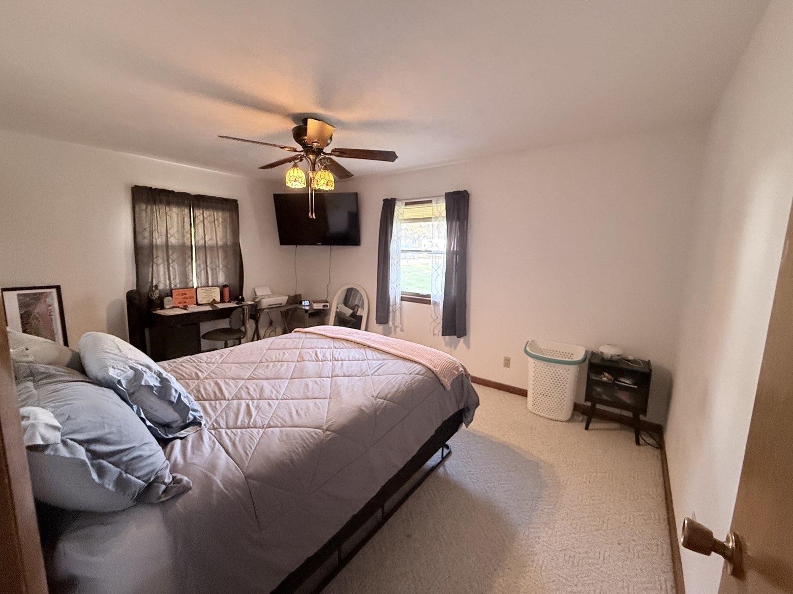 214 South Long Street Warren, IL 61087 - Photo 12 of 28 a bedroom with a bed and a chandelier