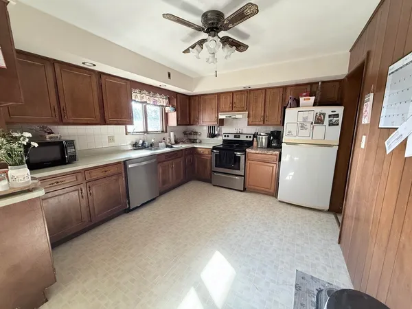 a kitchen with refrigerator a sink and cabinets