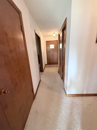 a bathroom with a granite countertop sink a mirror and shower