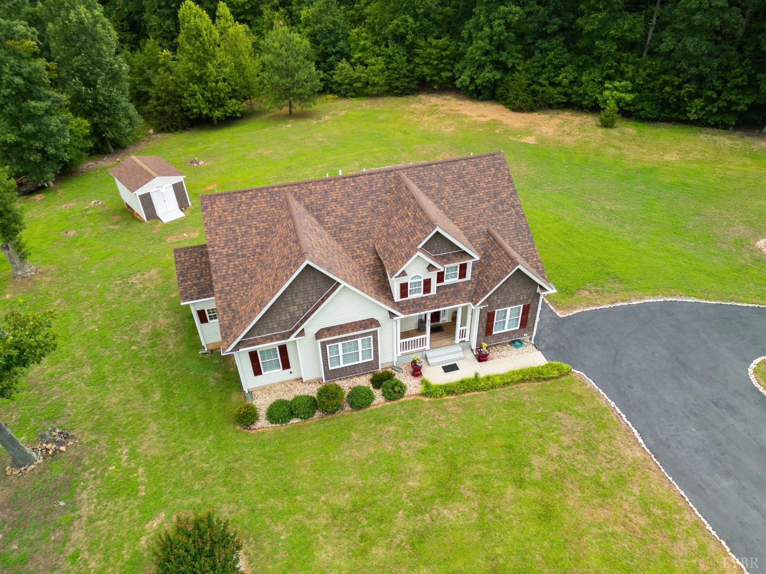 615 Spring Street Hurt, VA 24563 - Photo 4 of 63 an aerial view of a house with a garden and swimming pool