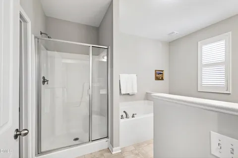 a bathroom with a tub sink and a mirror