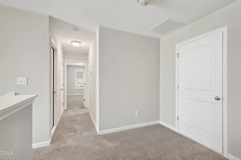 a view of an empty room with windows