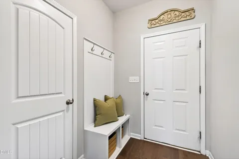 a view of a hallway with closet and wooden floor