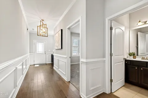 a dining room with wooden floor and furniture