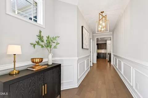 a view of a hallway view with wooden floor and staircase