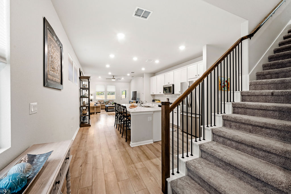 2417 Roosevelt Road Leander, TX 78641 - Photo 23 of 40 Staircase with wood finished floors, ceiling fan, and recessed lighting