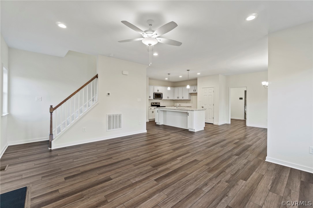 211 Edwin Circle Aylett, VA 23009 - Photo 16 of 48 a view of an empty room with wooden floor and a ceiling fan