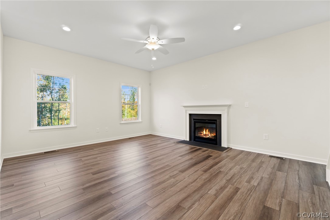 211 Edwin Circle Aylett, VA 23009 - Photo 40 of 48 a view of an empty room with wooden floor fireplace and a window