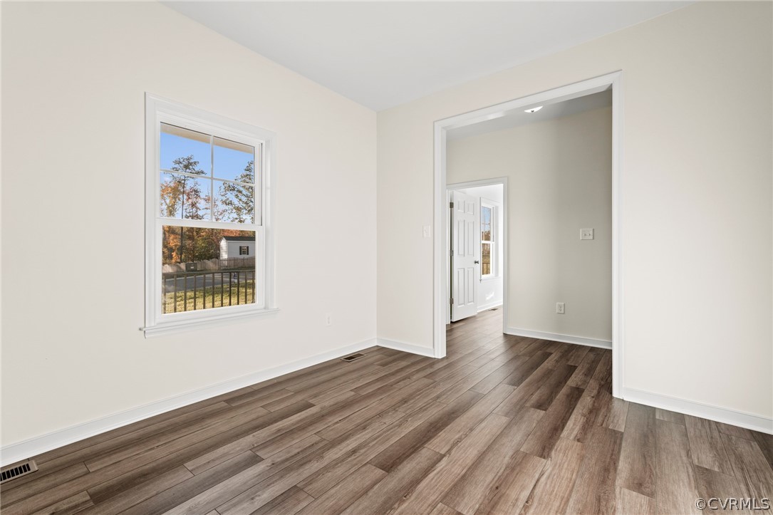 211 Edwin Circle Aylett, VA 23009 - Photo 42 of 48 a view of an empty room with wooden floor and a window