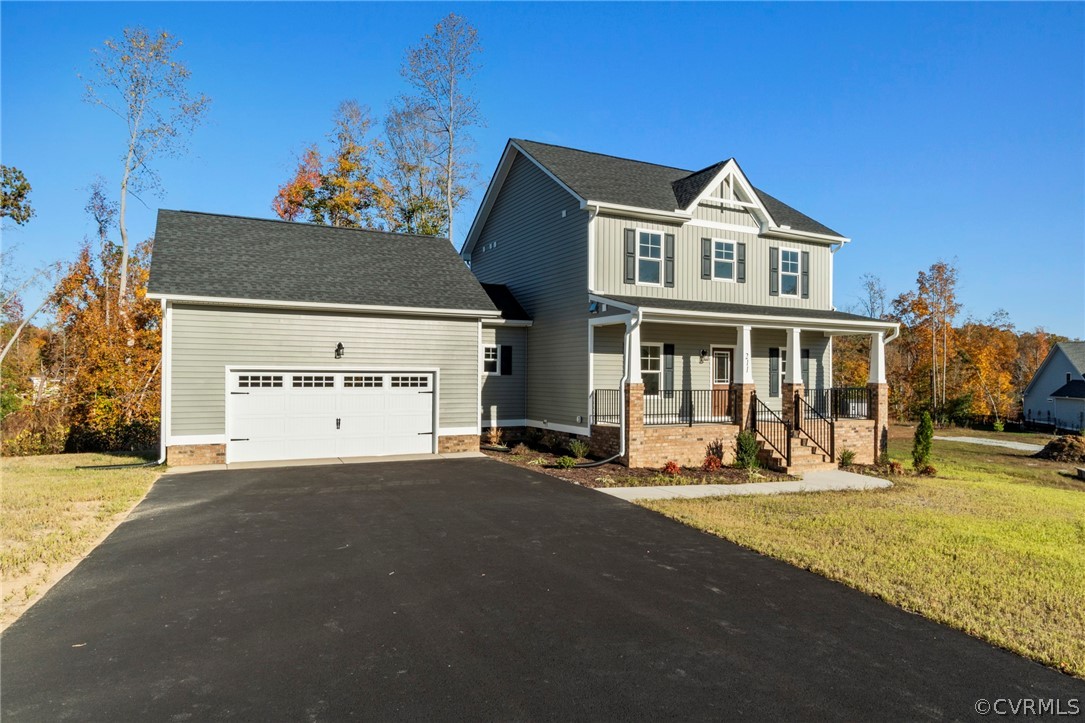 211 Edwin Circle Aylett, VA 23009 - Photo 45 of 48 a front view of a house with a yard and garage