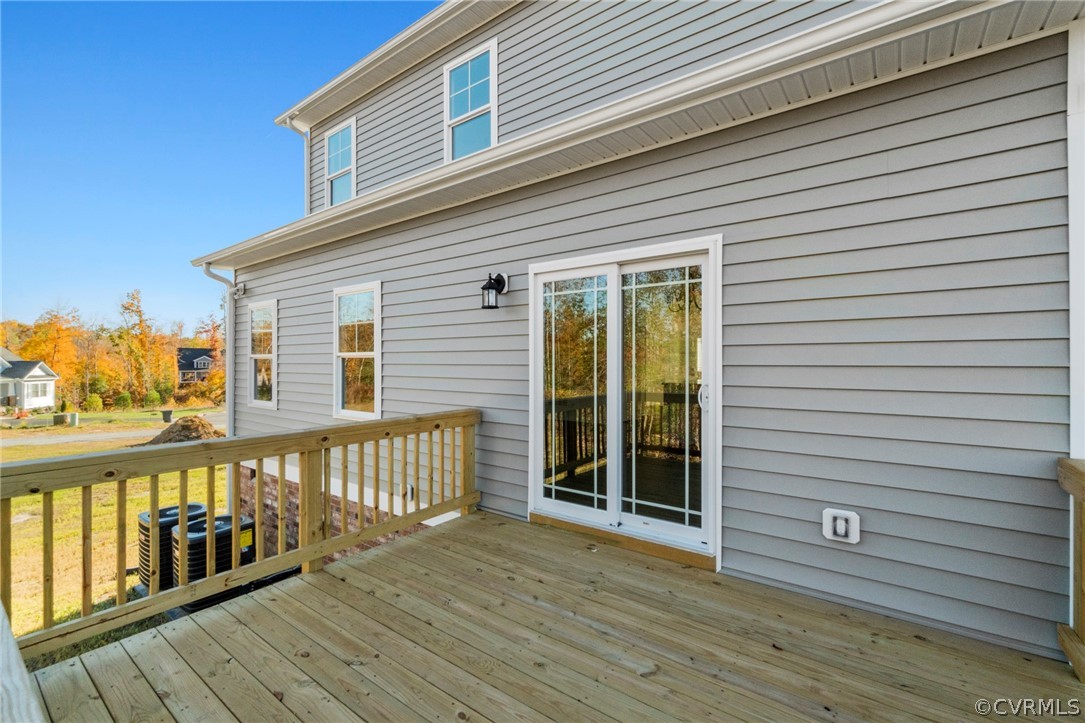 211 Edwin Circle Aylett, VA 23009 - Photo 10 of 48 a view of a deck with wooden floor and floor to ceiling window