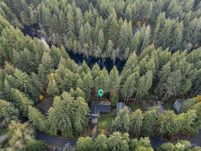 an aerial view of a house with a yard