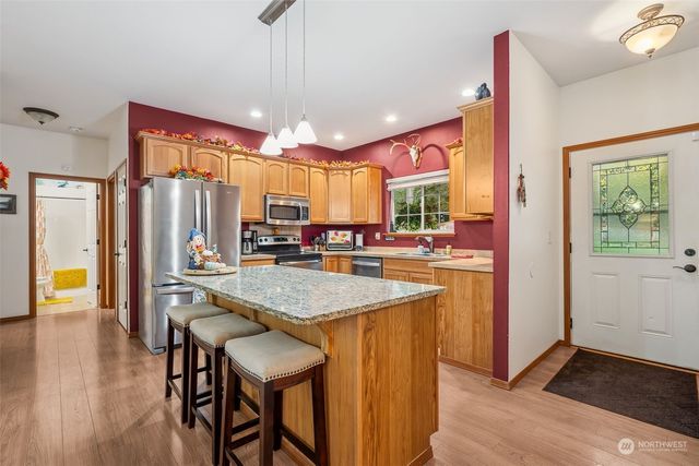 a large kitchen with a table and chairs