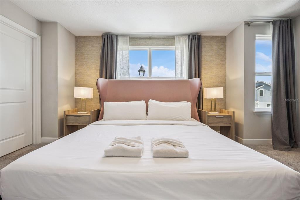 8008 Formosa Valley Place Kissimmee, FL 34747 - Photo 17 of 55 a bedroom with a large bed and a large window