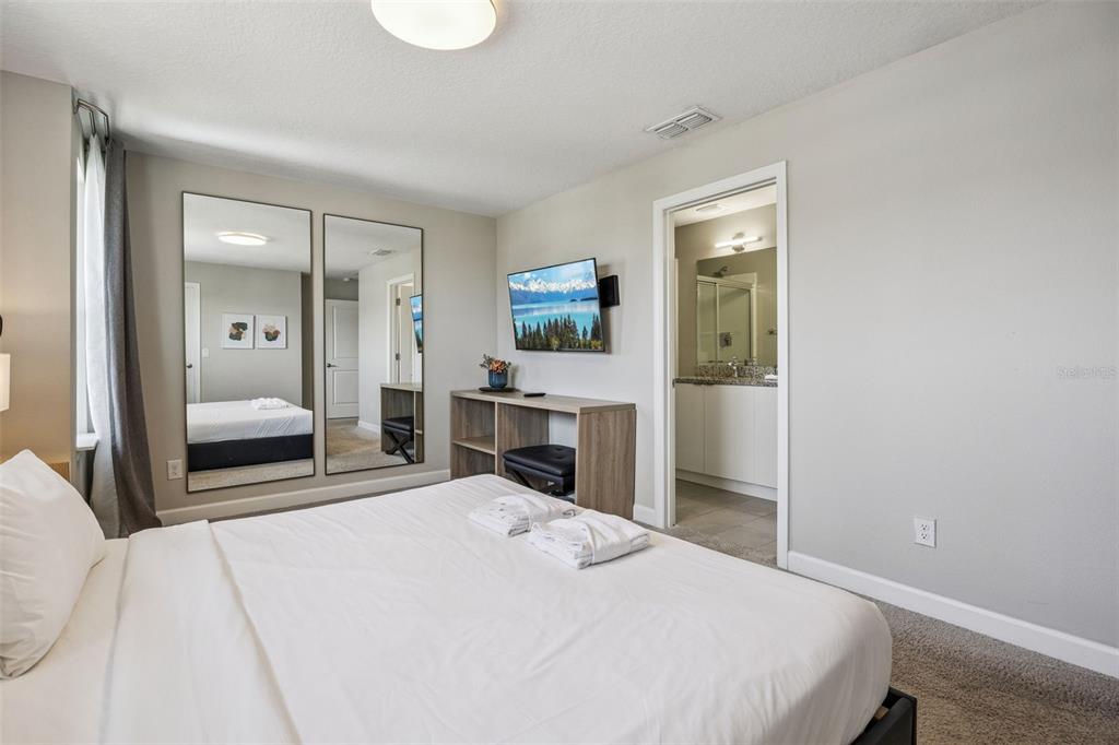 8008 Formosa Valley Place Kissimmee, FL 34747 - Photo 18 of 55 a bedroom with a bed and a large mirror