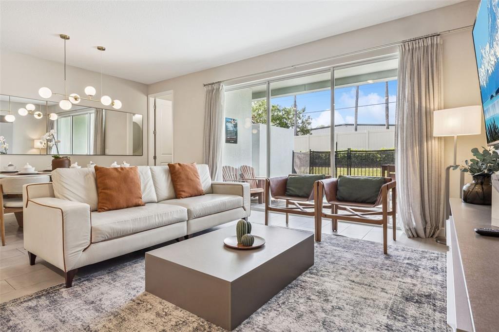 8008 Formosa Valley Place Kissimmee, FL 34747 - Photo 2 of 55 a living room with furniture and a large window