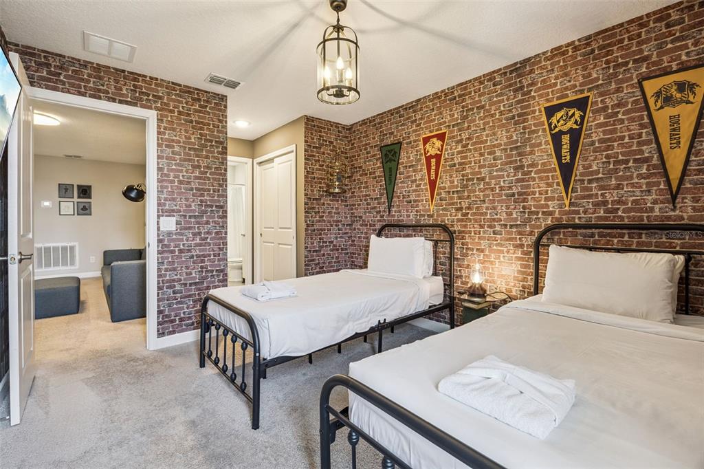 8008 Formosa Valley Place Kissimmee, FL 34747 - Photo 22 of 55 a spacious bedroom with two beds and a table
