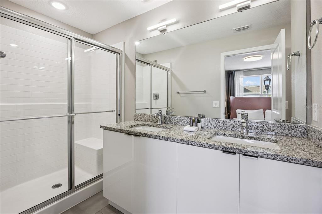 8008 Formosa Valley Place Kissimmee, FL 34747 - Photo 23 of 55 a bathroom with a granite countertop sink and a mirror