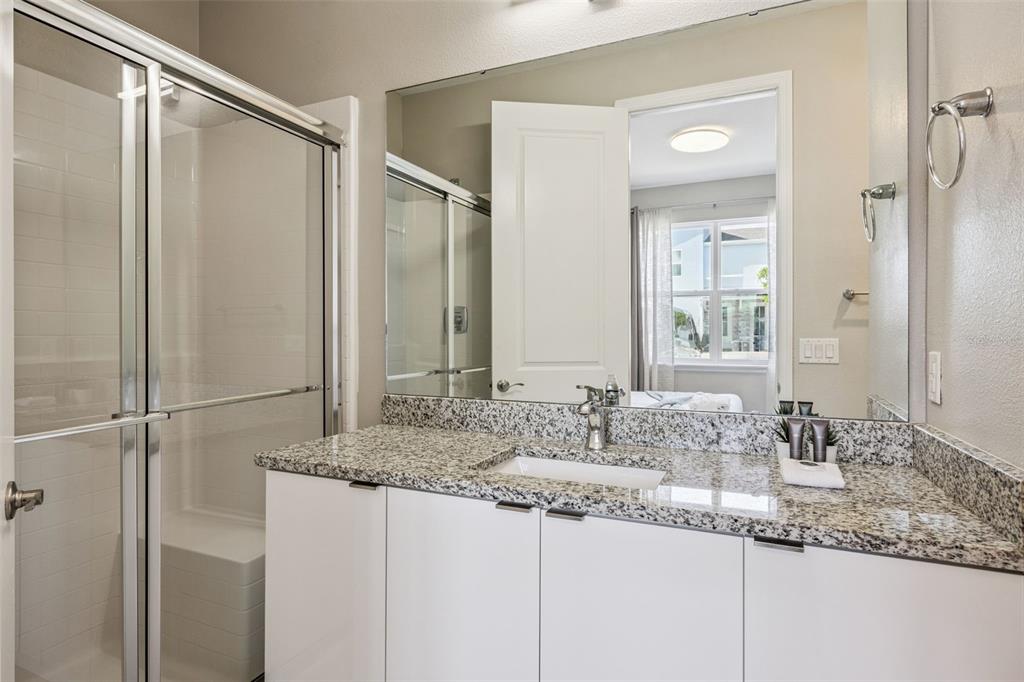 8008 Formosa Valley Place Kissimmee, FL 34747 - Photo 24 of 55 a bathroom with a granite countertop sink and a mirror