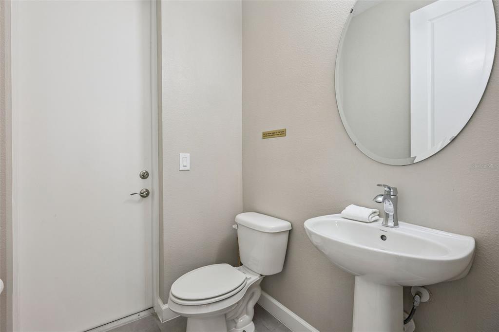8008 Formosa Valley Place Kissimmee, FL 34747 - Photo 27 of 55 a bathroom with a sink toilet and a mirror