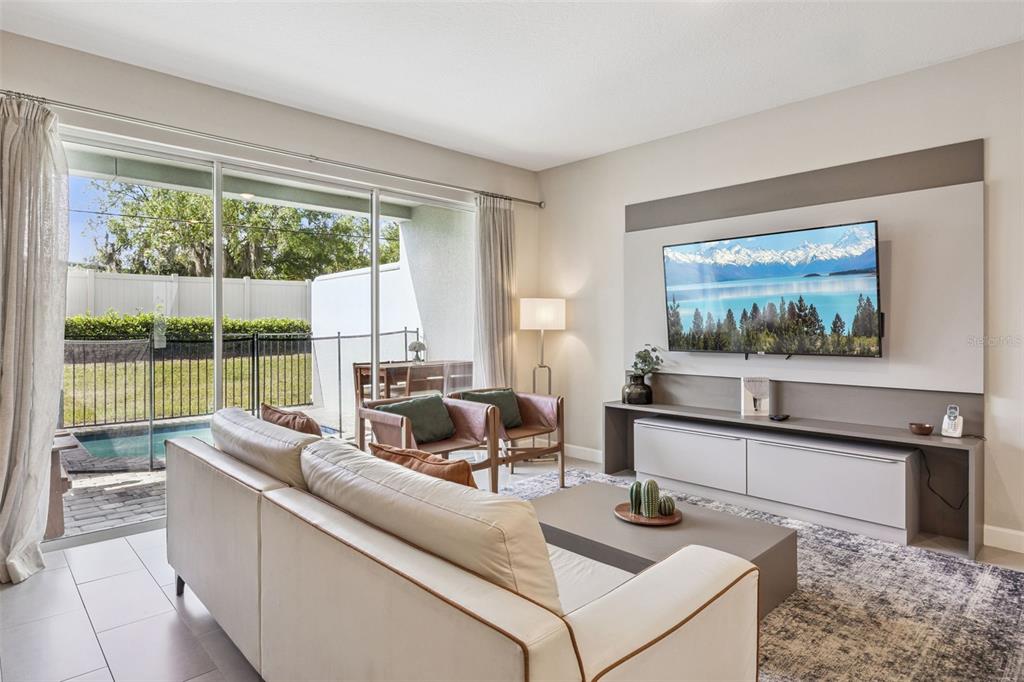 8008 Formosa Valley Place Kissimmee, FL 34747 - Photo 4 of 55 a living room with furniture and a large window