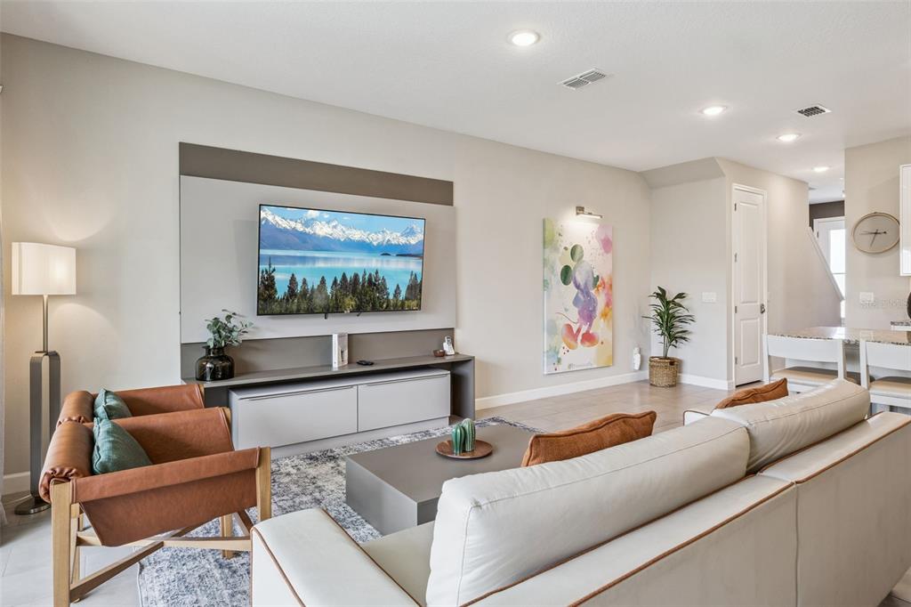 8008 Formosa Valley Place Kissimmee, FL 34747 - Photo 5 of 55 a living room with furniture and a flat screen tv