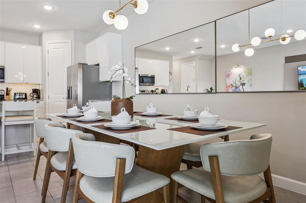 8008 Formosa Valley Place Kissimmee, FL 34747 - Photo 7 of 55 a kitchen with a dining table and chairs