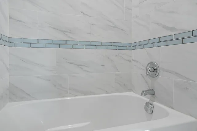 a bathroom with a shower and a bathtub