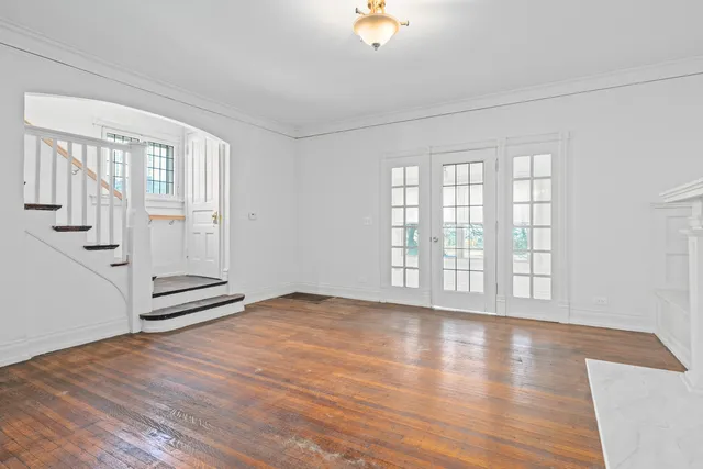 wooden floor in an empty room with a window