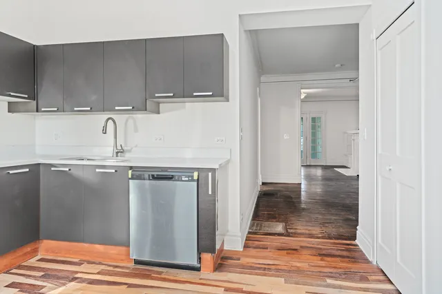 a kitchen with granite countertop a sink and cabinets