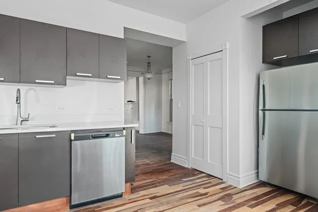 a view of a refrigerator in kitchen and wooden floor