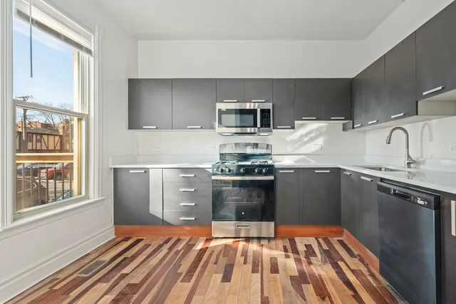 a kitchen with granite countertop a stove top oven and sink