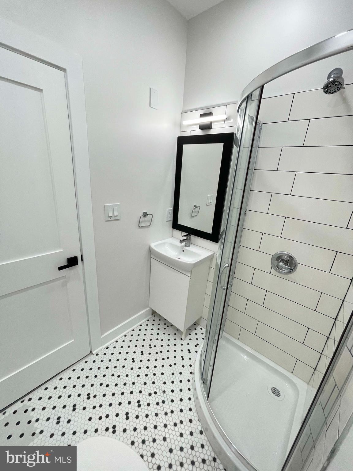 309 South 60th Street, Unit 1 Philadelphia, PA 19143 - Photo 16 of 17 a bathroom with a sink toilet and shower