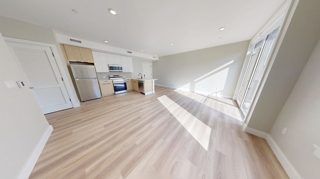 211 Green Street, Unit 401 Boston, MA 02130 - Photo 3 of 11 a bed room with a bed and furniture