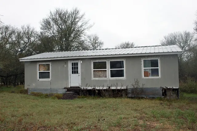 a house with trees in the background