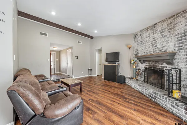 a living room with furniture and a fireplace