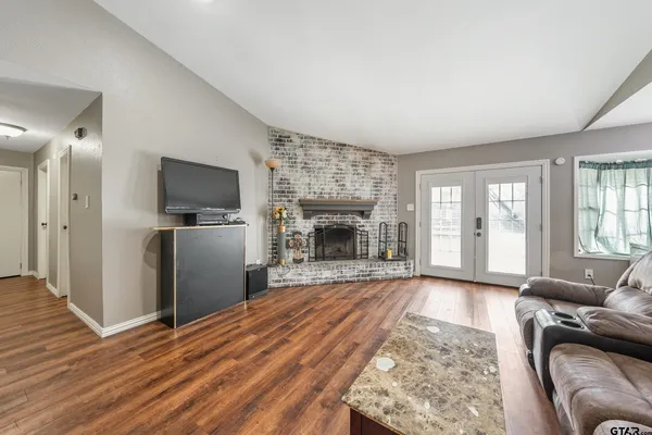 a living room with furniture and a fireplace