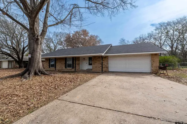 front view of a house with a large tree