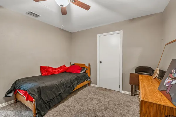 a bedroom with a bed and a dresser