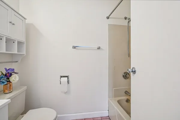 a bathroom with a sink mirror and toilet