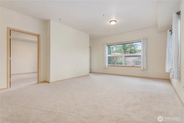 an empty room with windows and closet