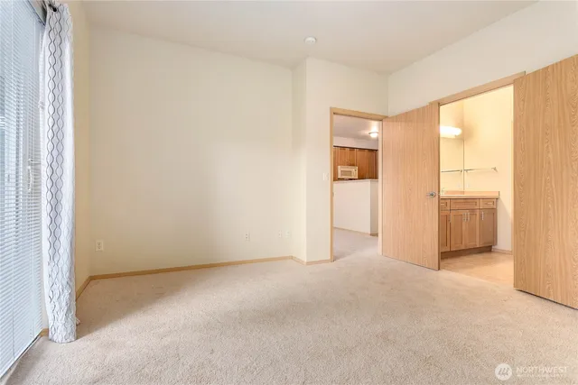 a view of an empty room and a window