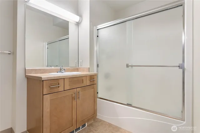 a bathroom with a sink mirror and a vanity