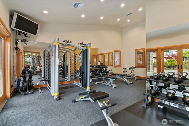 a view of a room with gym equipment and a large window